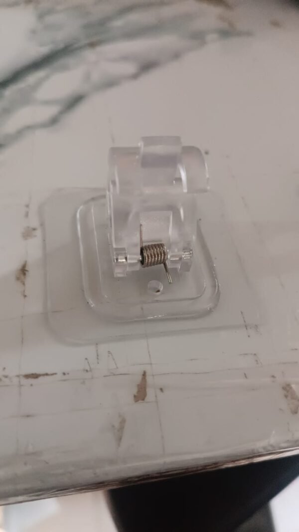 0430b06e-ab32-43df-9038-762e3a1a5570.jpg Wall Mount Transparent Self-Adhesive Clip with Strong Spring Grip