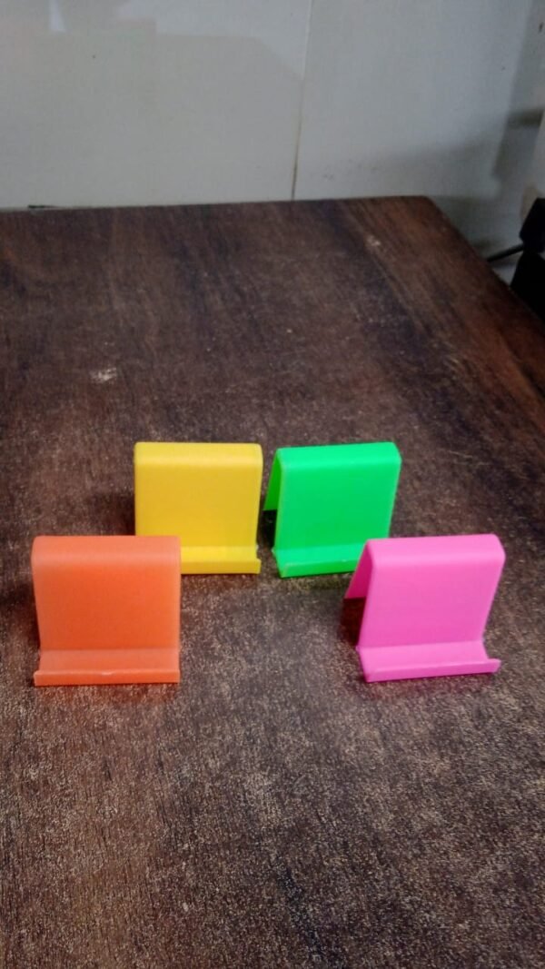 2a2df057-cbc6-4677-acf7-cd6c4007cda2_90a0c26a-46fe-4564-8d77-f314aa3cda84.jpg Durable Plastic Mobile Phone Stand with Angled Support (1 Pc / Mix Color)