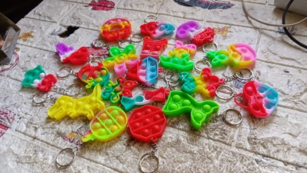 4afe7fb5-bde2-46bc-b9fa-20558cd4084c.jpg Compact Pop It Keychain – Fun Stress Relief Fidget Toy (1 Pc | Mix Design)